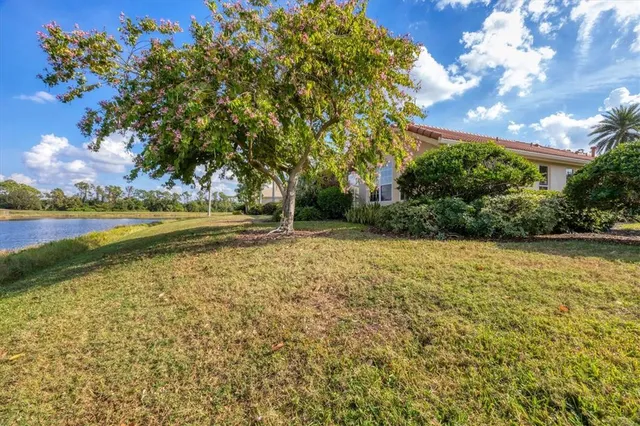 an aerial view of a house with a lake view
