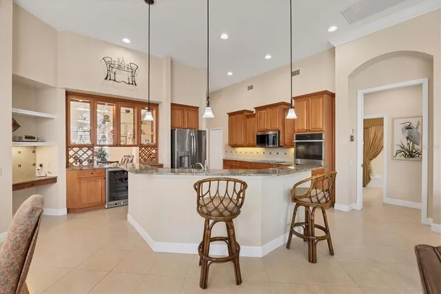 a kitchen with stainless steel appliances kitchen island a large counter top space appliances and cabinets