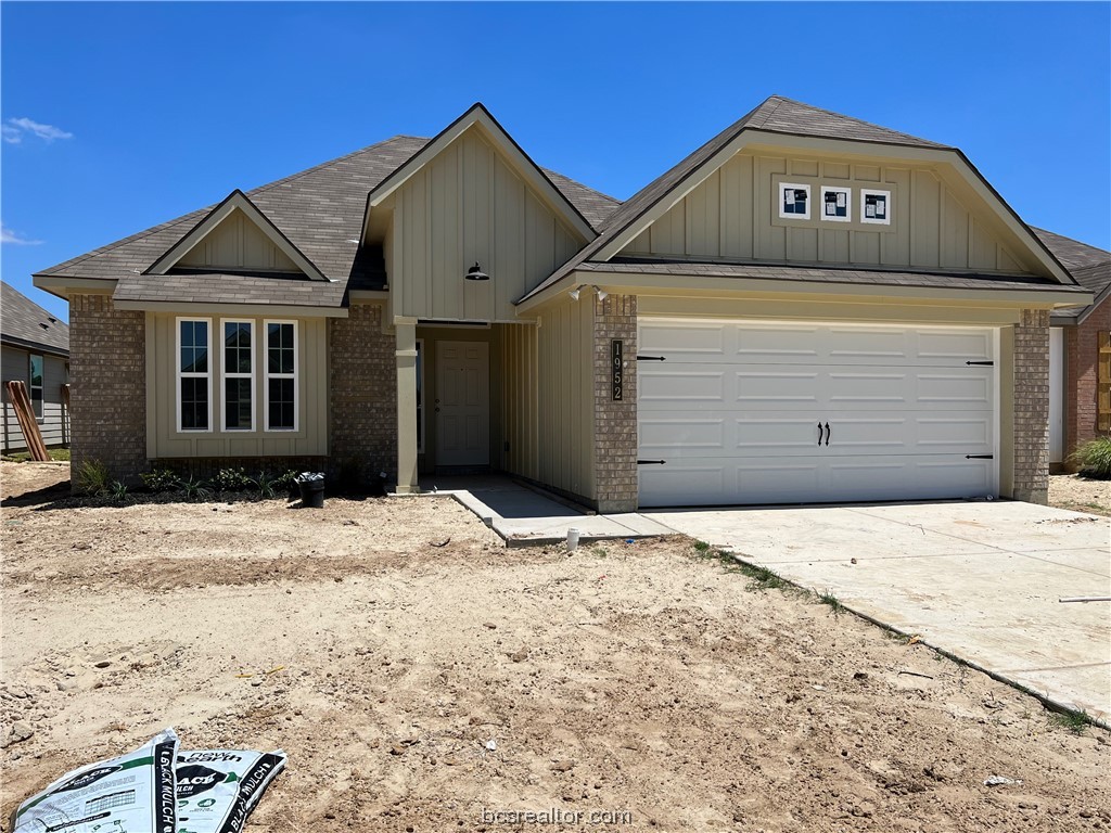 a front view of a house with a garage