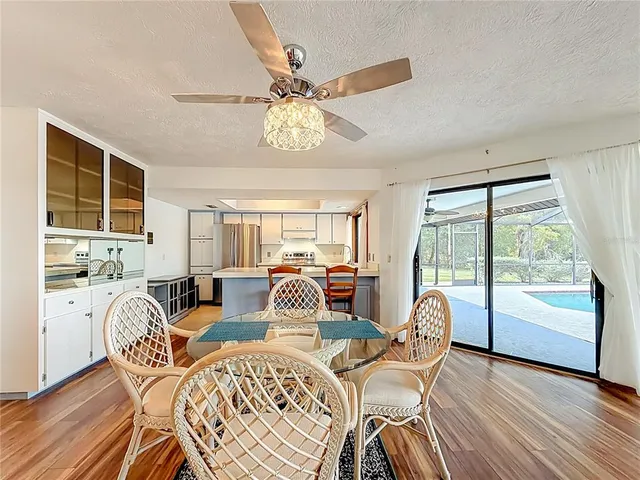 a view of a livingroom with furniture and a ceiling fan