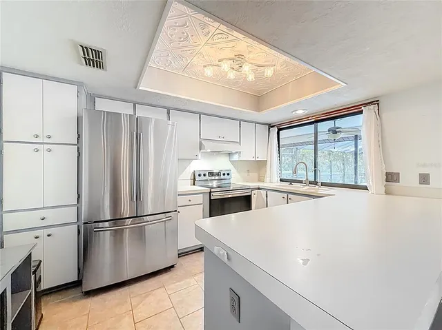 an empty room with windows and a ceiling fan
