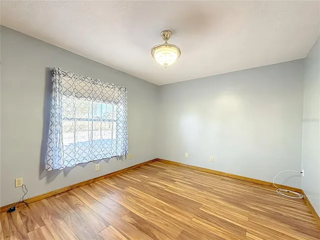 an empty room with windows and closet