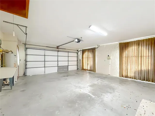 an aerial view of residential houses with outdoor space and river