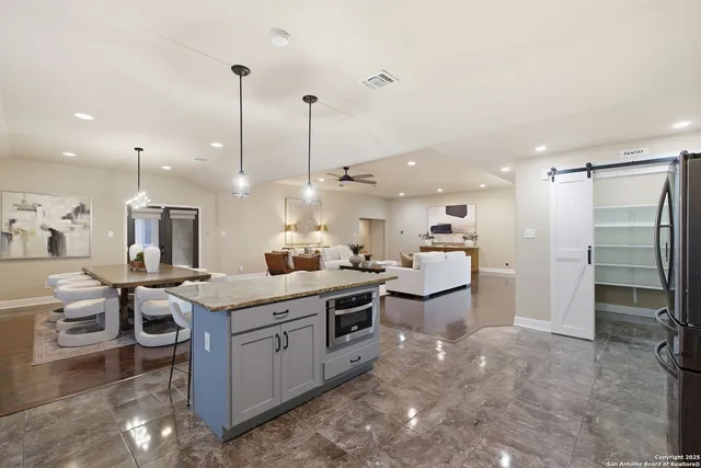 a kitchen with a sink stainless steel appliances and cabinets