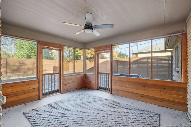 a large room with a large window and furniture