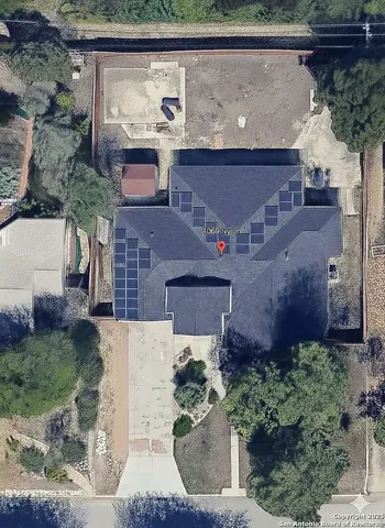 an aerial view of a house with a yard and a fountain
