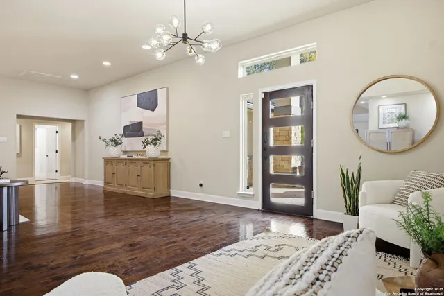 a view of a bedroom with wooden floor and furniture