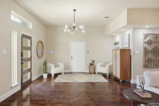 a bedroom with furniture and a chandelier