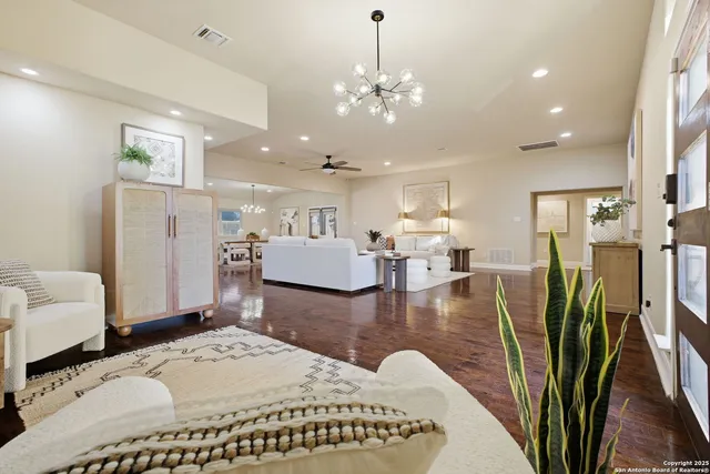 a living room with fireplace furniture and a chandelier