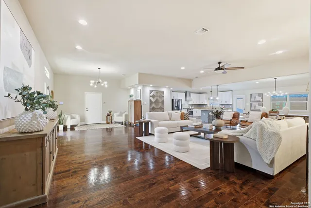 a living room with fireplace furniture and a potted plant