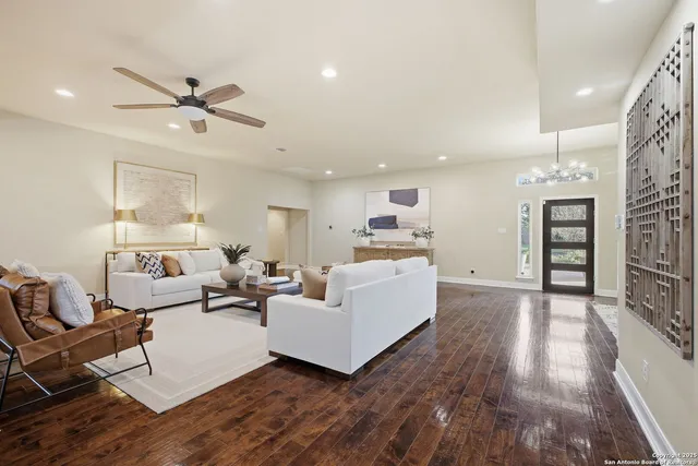 a living room with furniture and kitchen view