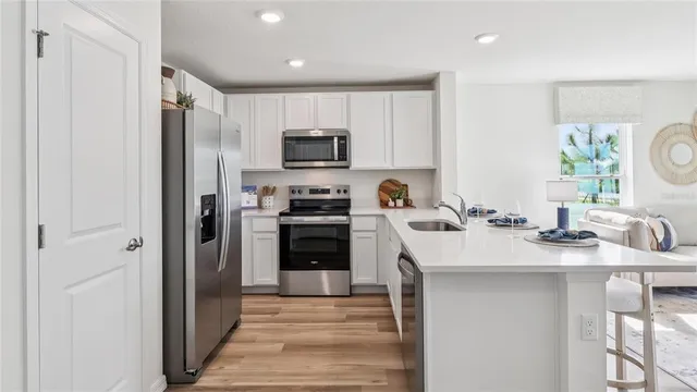 a kitchen with a sink a stove a refrigerator and a sink