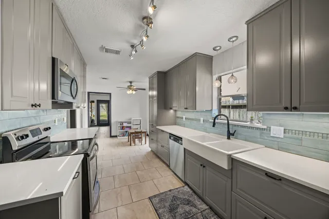 a kitchen with a sink and refrigerator