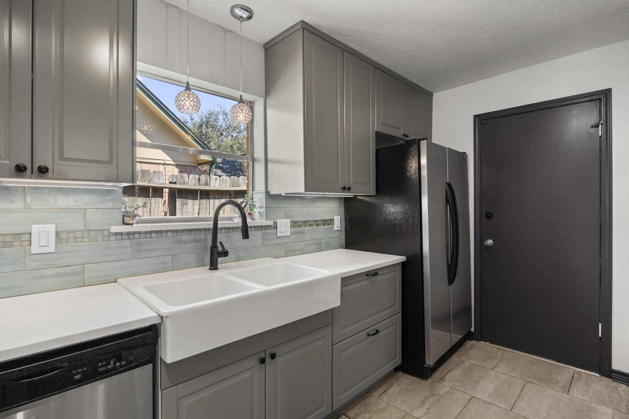 810 Hidden Canyon Road Katy, TX 77450 - Photo 13 of 33 This angle showcases the generous sink area alongside the refrigerator. Pendant lighting above the sink adds a designer touch, while the layout maximizes storage, counter space, and everyday convenience.