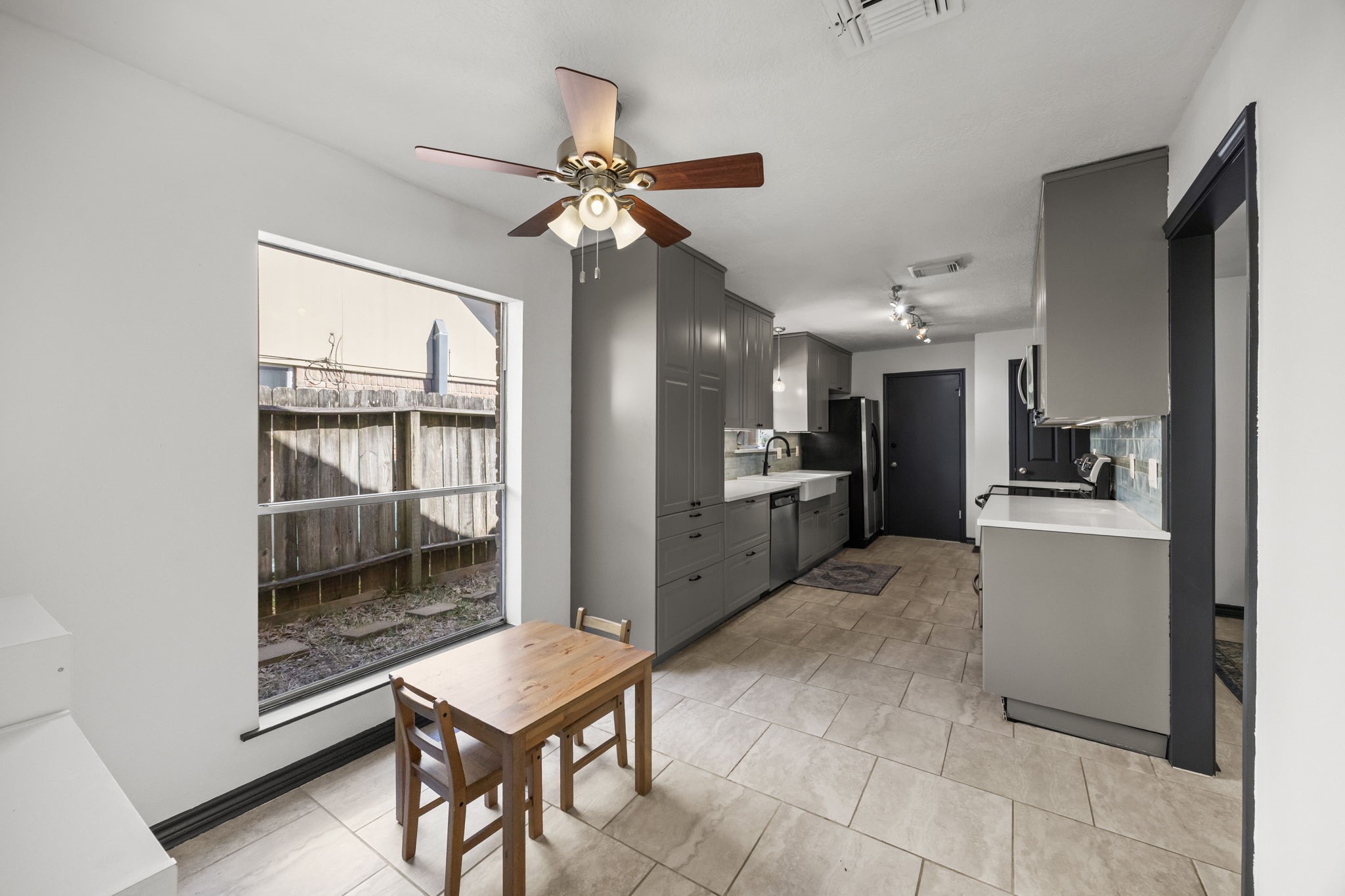 810 Hidden Canyon Road Katy, TX 77450 - Photo 15 of 33 Tile flooring continues seamlessly throughout, while the ceiling fan with light provides comfort for everyday meals.