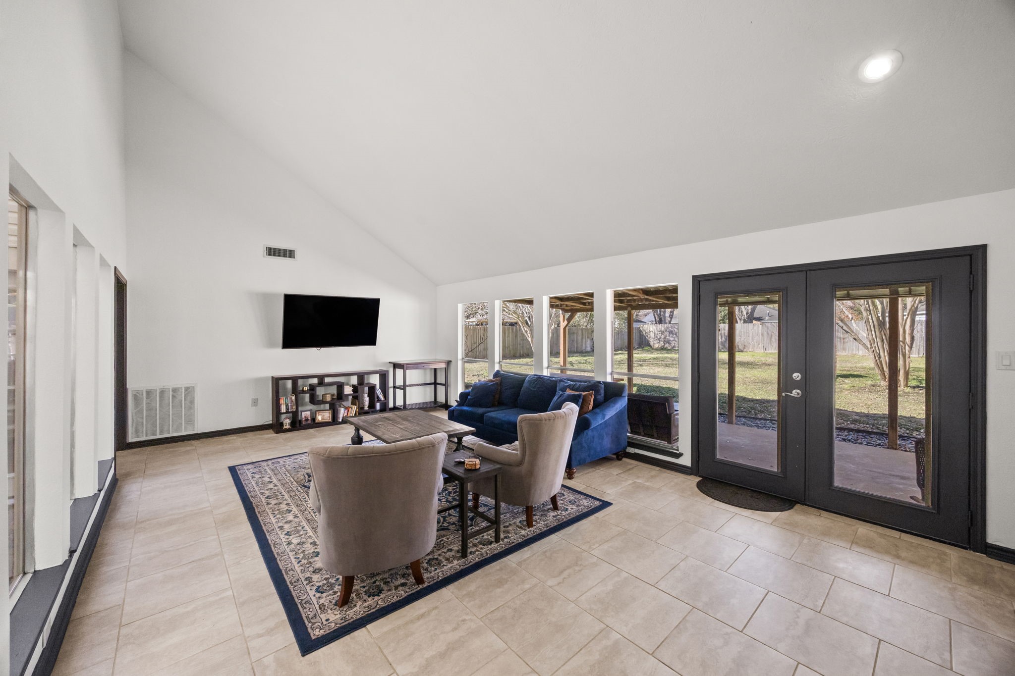 810 Hidden Canyon Road Katy, TX 77450 - Photo 17 of 33 A wide view showcases walls of windows and French doors that open to the covered patio, bringing the outdoors in. Natural light fills the room, highlighting the generous proportions and making this space ideal for relaxing or entertaining.