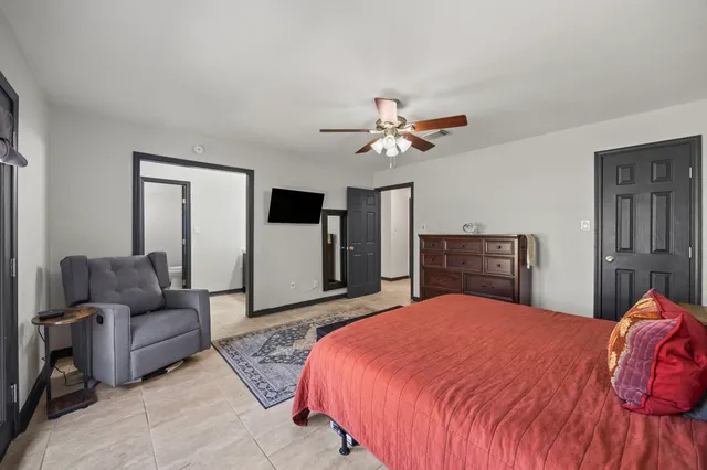 a bed room with a bed and a painting on the wall