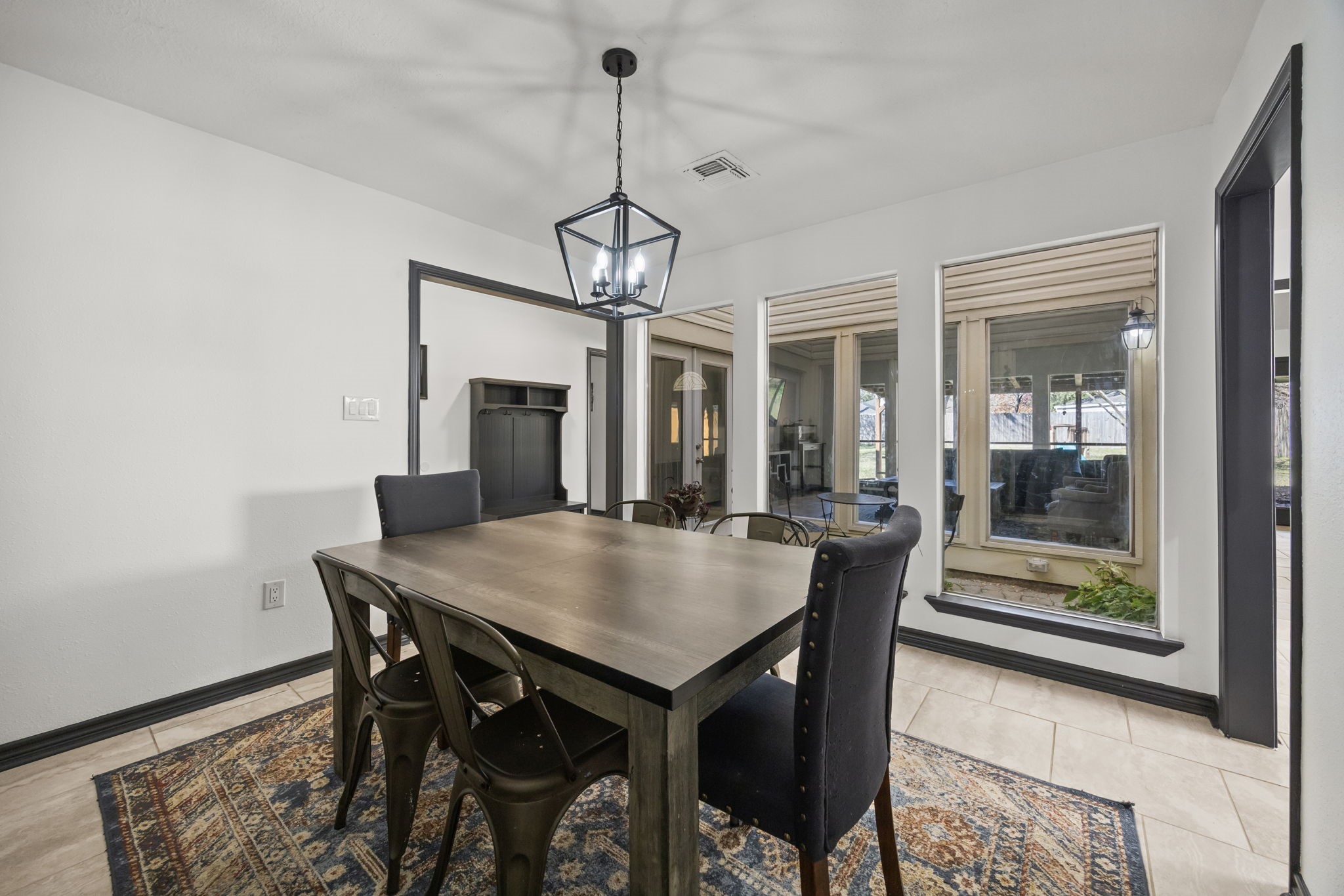 810 Hidden Canyon Road Katy, TX 77450 - Photo 8 of 33 This angle emphasizes the dining room’s connection to the enclosed atrium, with oversized interior windows that flood the space with natural light. The serene view adds visual interest and creates an inviting ambiance.