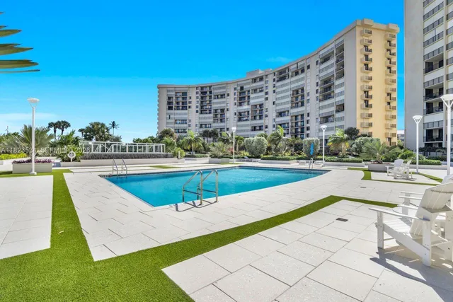 a view of a swimming pool with a lawn chairs