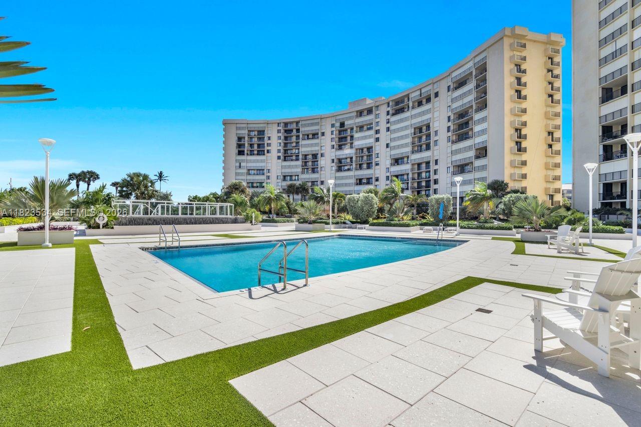 a view of a swimming pool with a lawn chairs