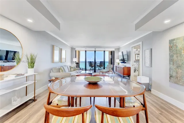 a dining room with furniture and wooden floor