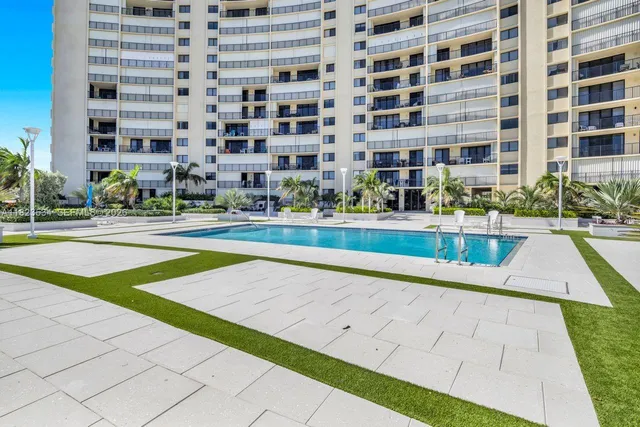 a view of building with yard and swimming pool