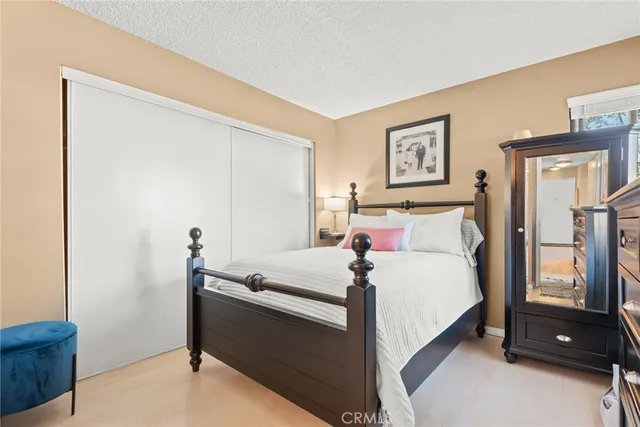 a bedroom with a bed and a closet