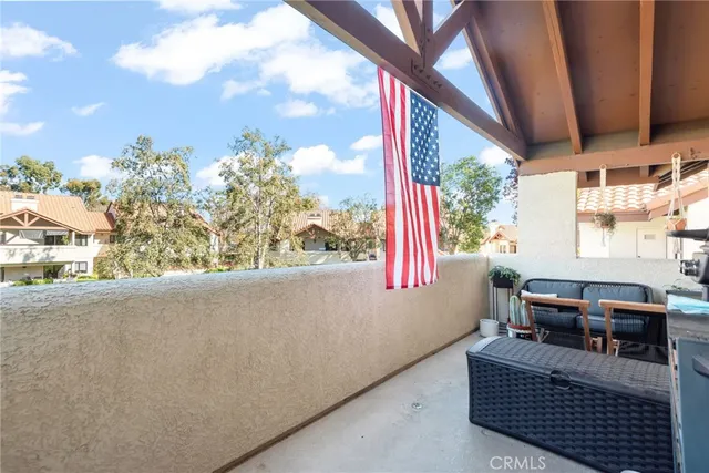 a living room with furniture a window and a potted plant