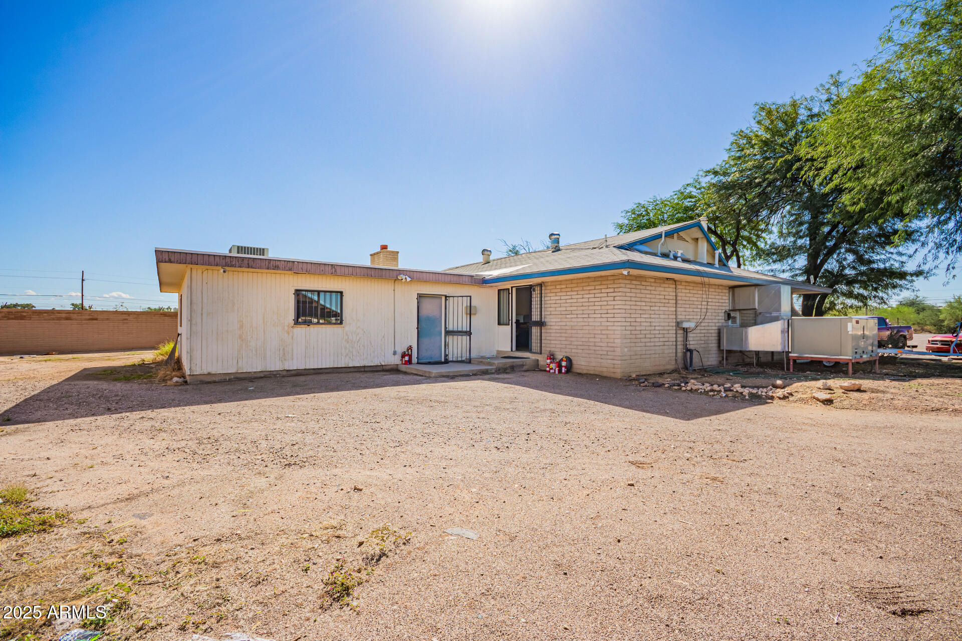 2925 East Ganley Road, Unit 121 Tucson, AZ 85706 - Photo 19 of 45 a view of a white house with a yard and garage