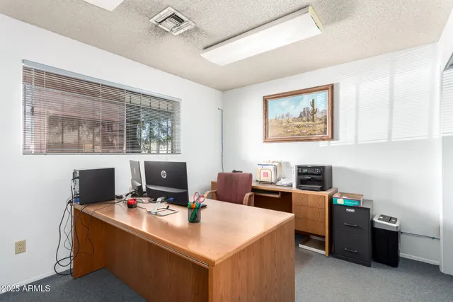 a work room with furniture and a wooden floor