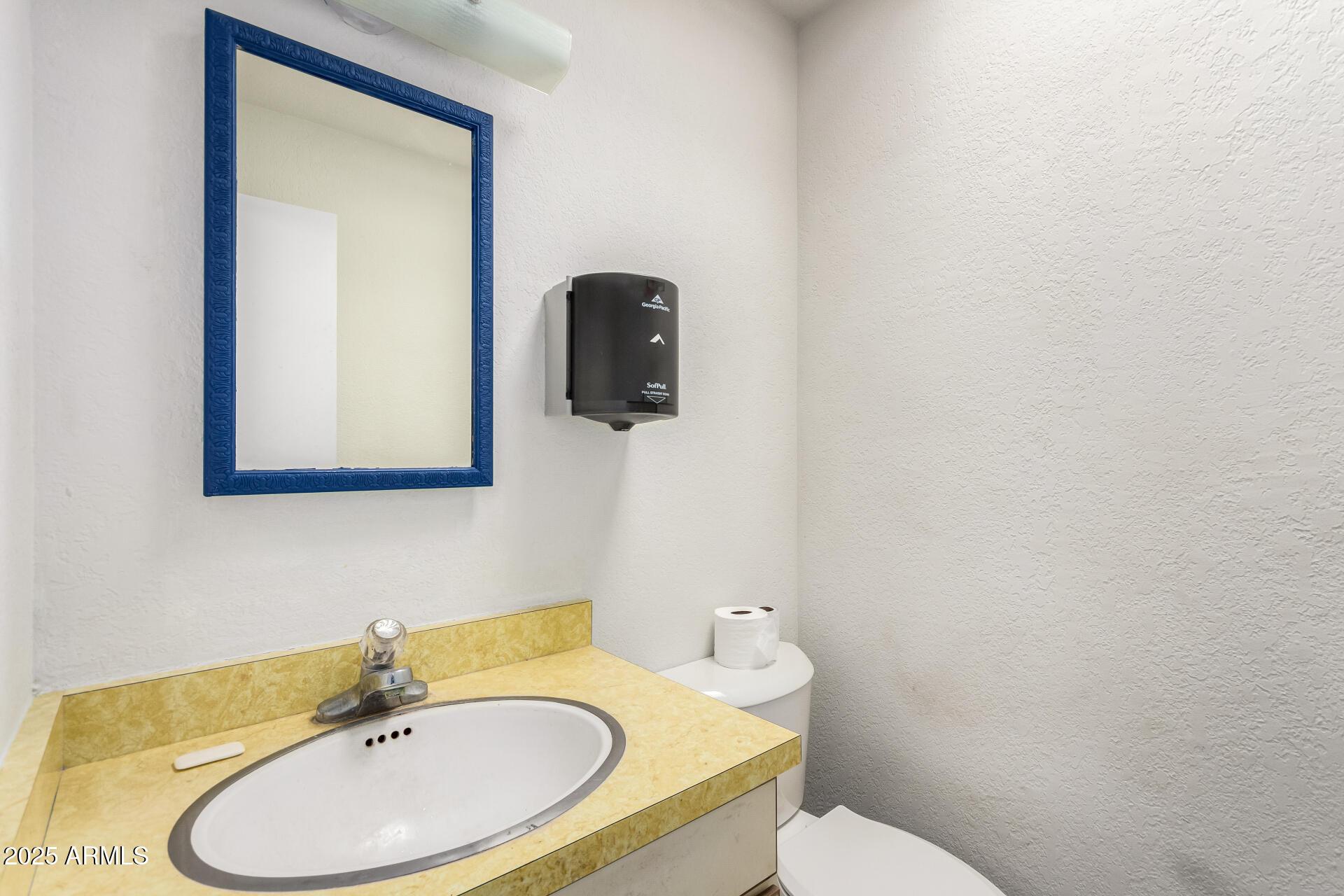 2925 East Ganley Road, Unit 121 Tucson, AZ 85706 - Photo 37 of 45 a bathroom with a toilet sink and mirror