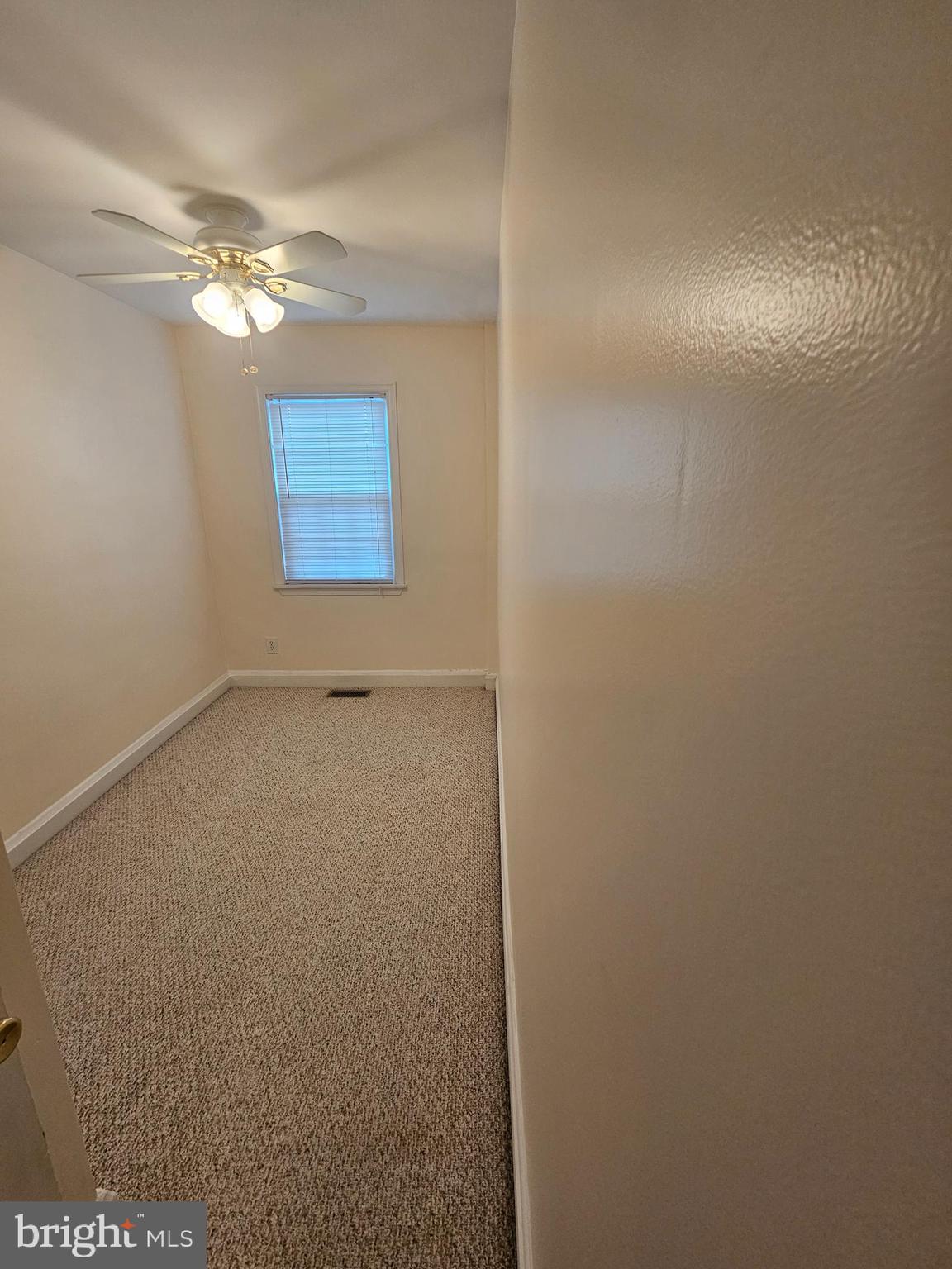 6907 Belclare Road Baltimore, MD 21222 - Photo 10 of 26 a view of an empty room with a chandelier fan