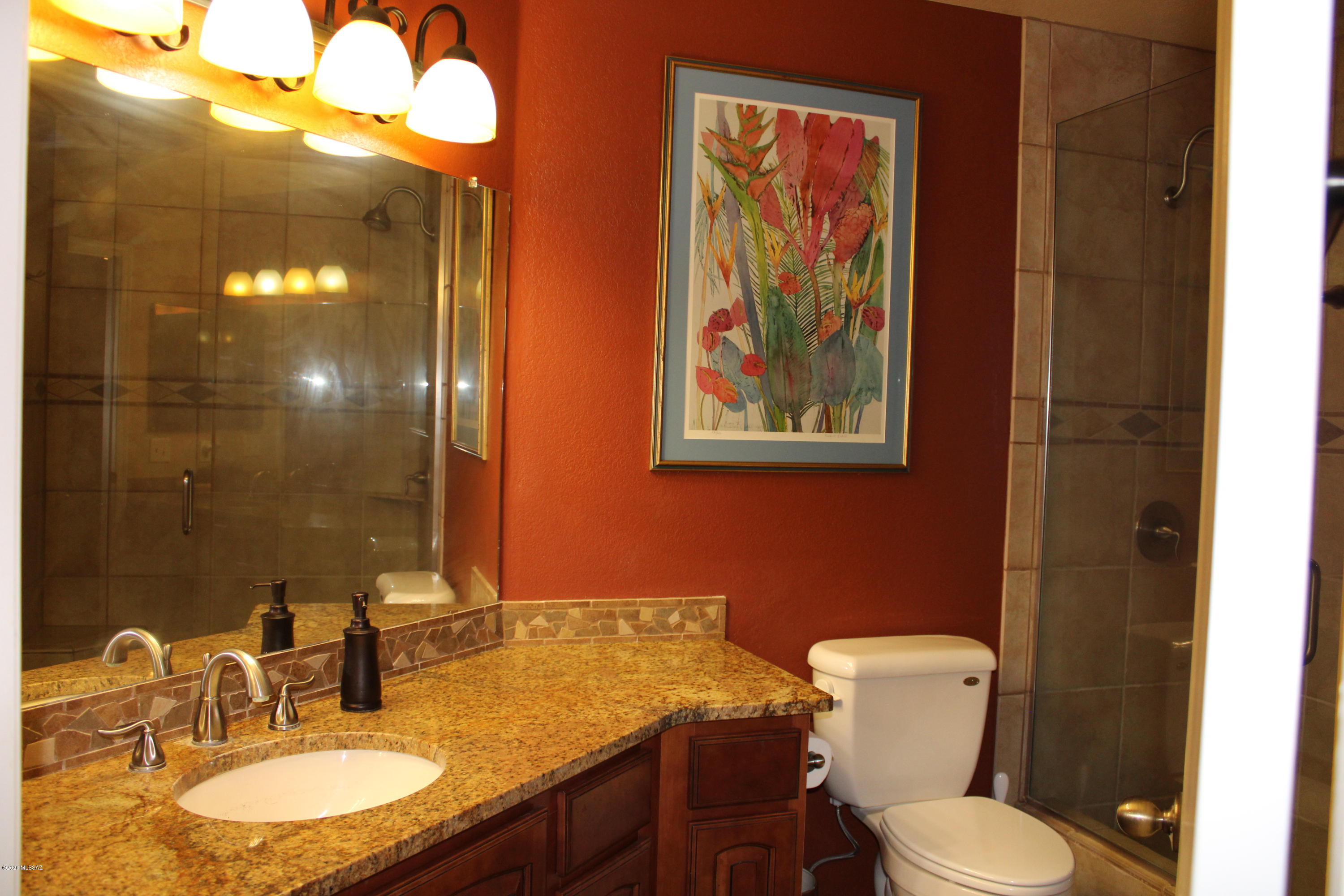 5751 North Kolb Road, Unit 36203 Tucson, AZ 85750 - Photo 18 of 25 a bathroom with a toilet a sink and mirror