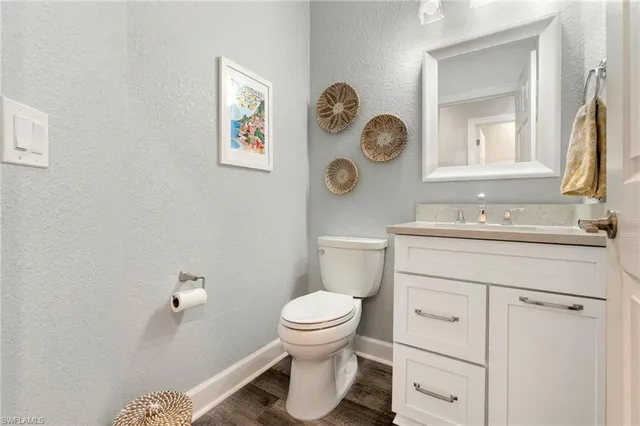 a bathroom with a toilet a sink and a mirror