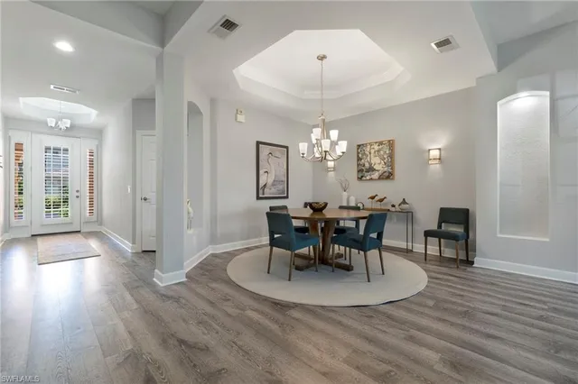 a view of a dining room with furniture and wooden floor