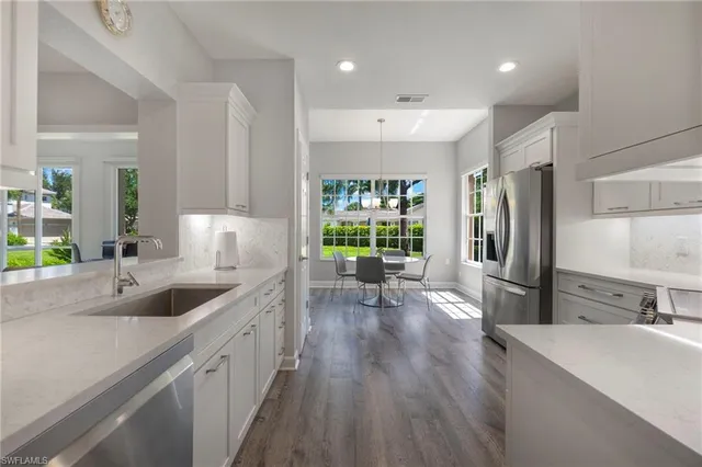 a kitchen with refrigerator and window