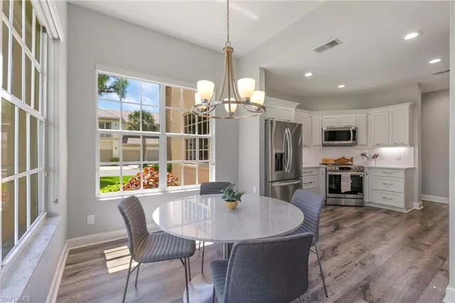 a view of a dining room with furniture and a chandelier