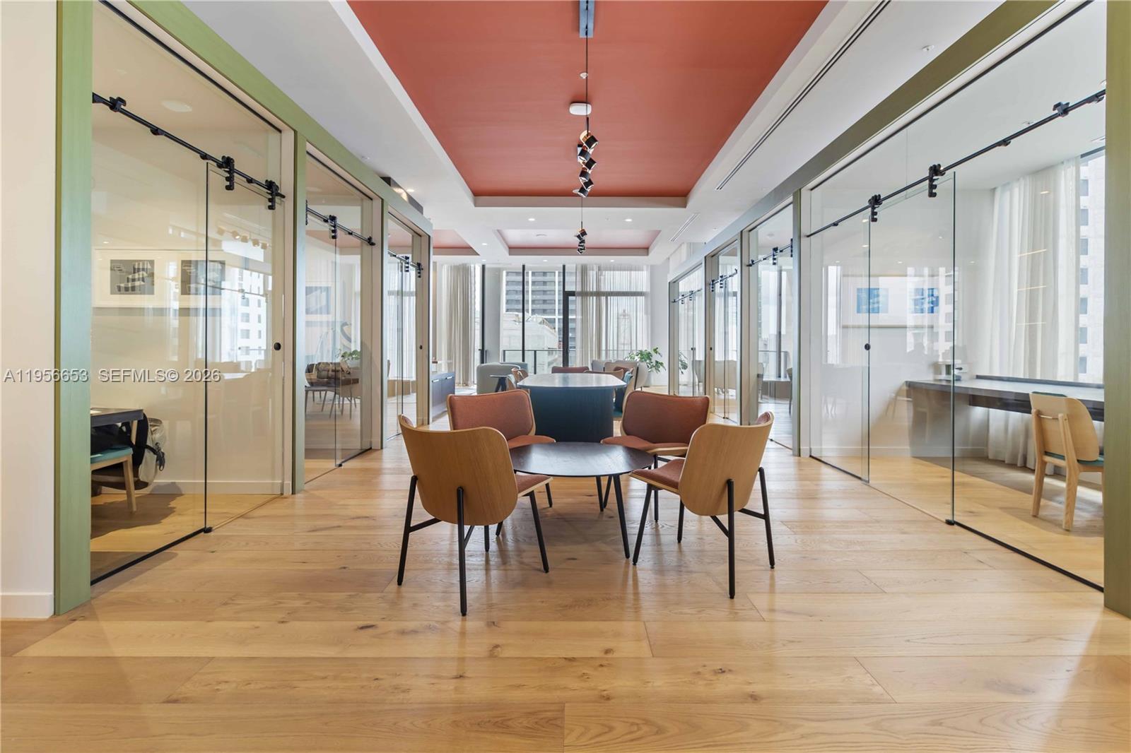 11 Northeast 6th Street, Unit 1513 Miami, FL 33132 - Photo 21 of 44 a dining room with furniture a chandelier and wooden floor