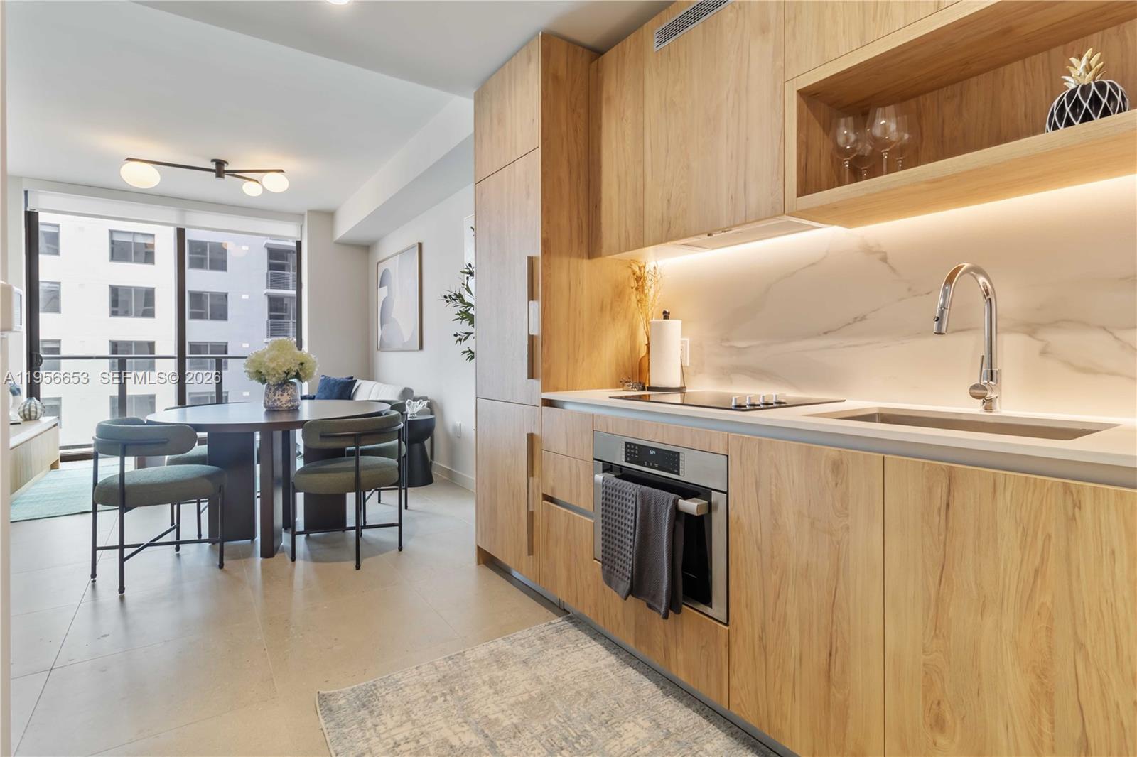 11 Northeast 6th Street, Unit 1513 Miami, FL 33132 - Photo 3 of 44 a kitchen with stainless steel appliances granite countertop a stove a sink and a refrigerator