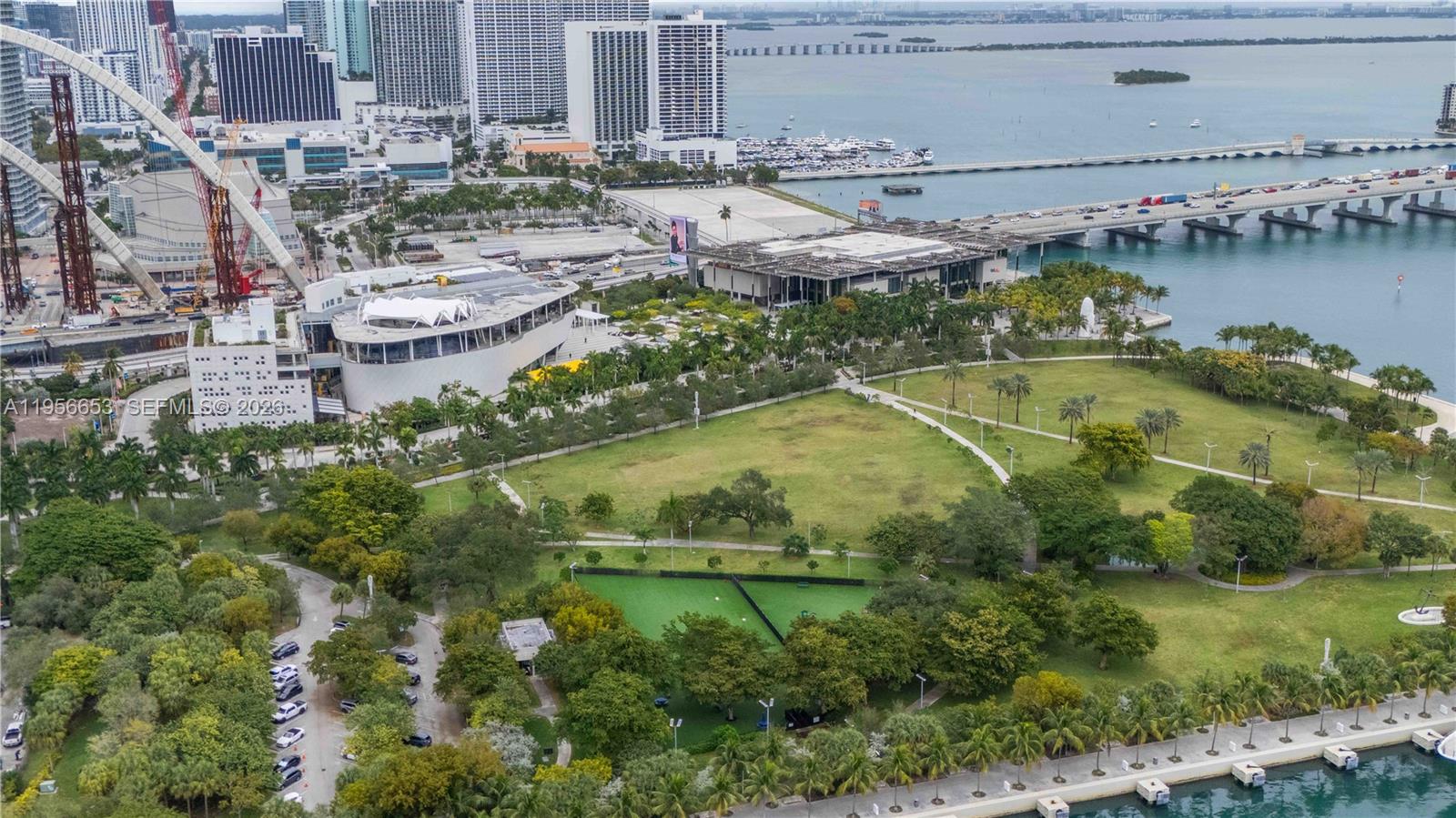 11 Northeast 6th Street, Unit 1513 Miami, FL 33132 - Photo 38 of 44 a view of a lake with a yard and large trees