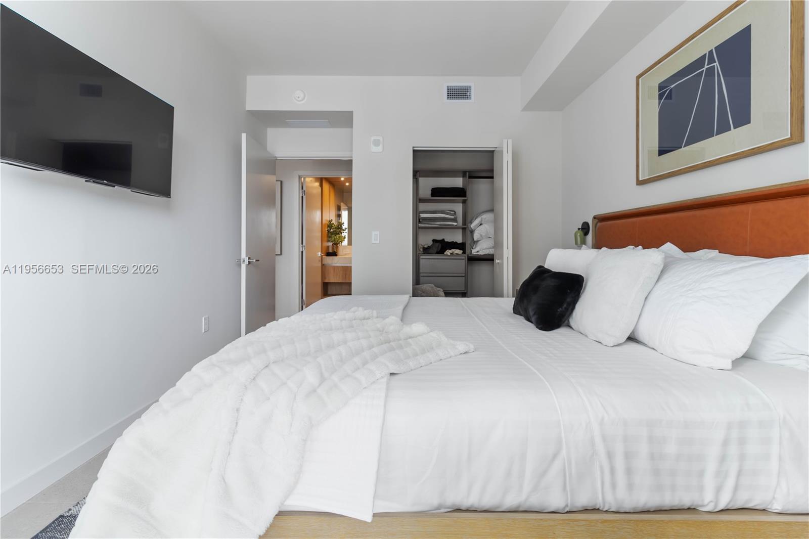 11 Northeast 6th Street, Unit 1513 Miami, FL 33132 - Photo 8 of 44 a bedroom with a bed and a flat screen tv