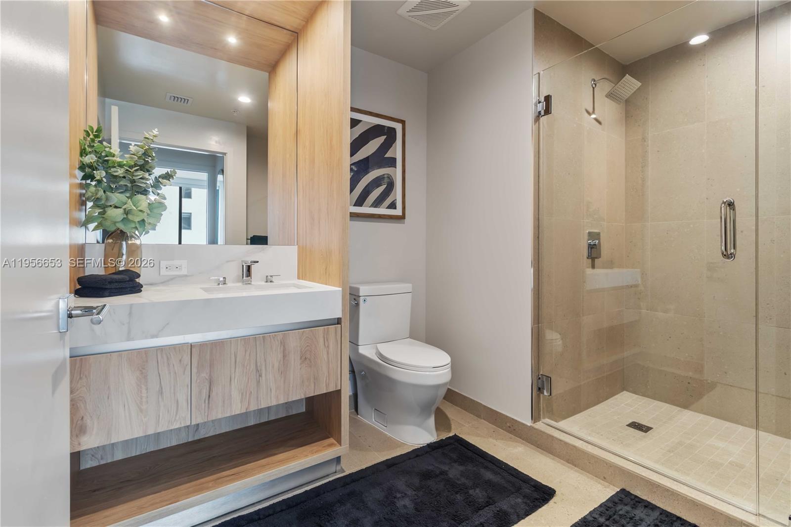 11 Northeast 6th Street, Unit 1513 Miami, FL 33132 - Photo 9 of 44 a bathroom with a sink a toilet and shower