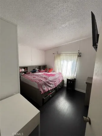 a bedroom with a bed and a chair in it