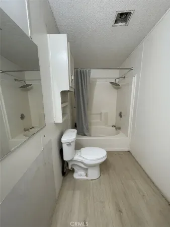a bathroom with a toilet sink and shower