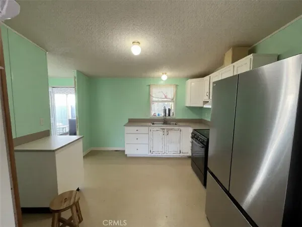 a kitchen with a refrigerator and a sink