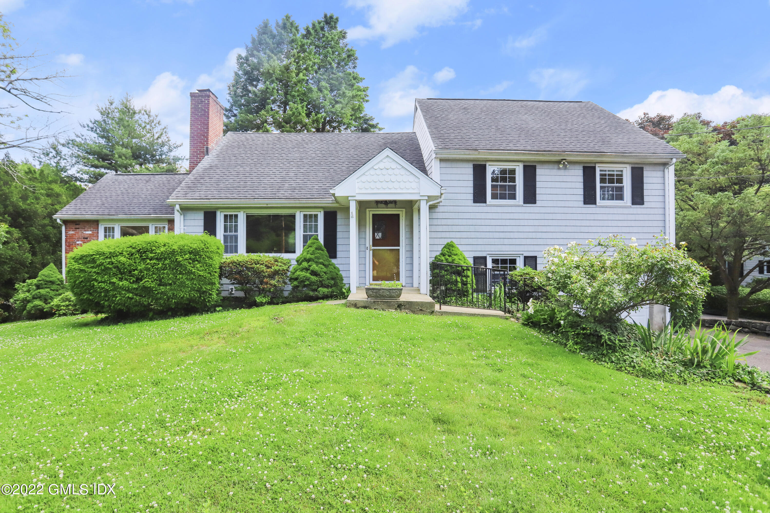 a front view of a house with a garden