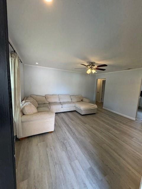 401 Reynolds Road Athens, TX 75751 - Photo 3 of 13 Living room featuring light gray wall paint, white trim boards and ceiling fan with light