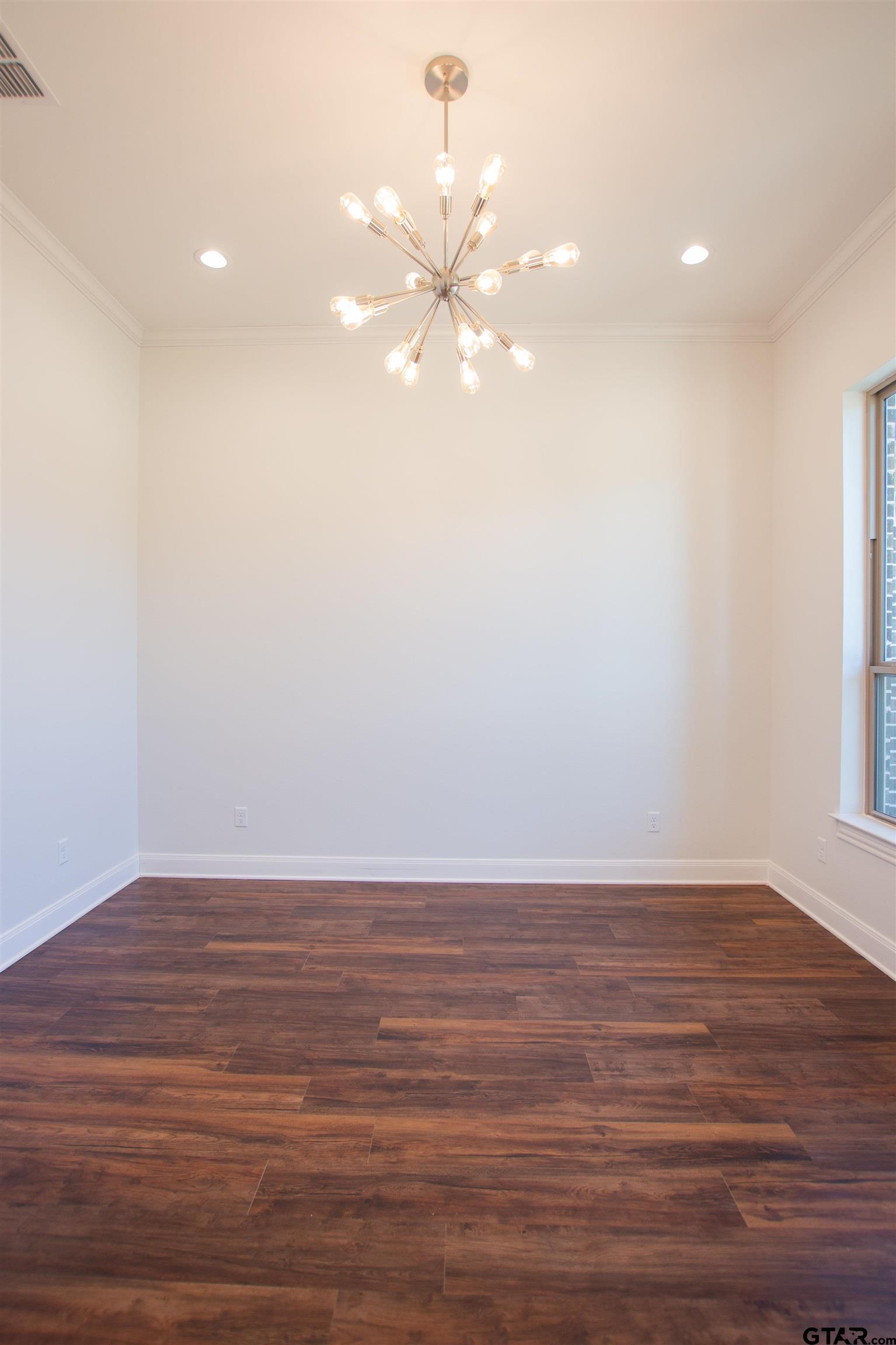 14716 Fallow Lane Tyler, TX 75706 - Photo 11 of 46 a view of an empty room with wooden floor and a window