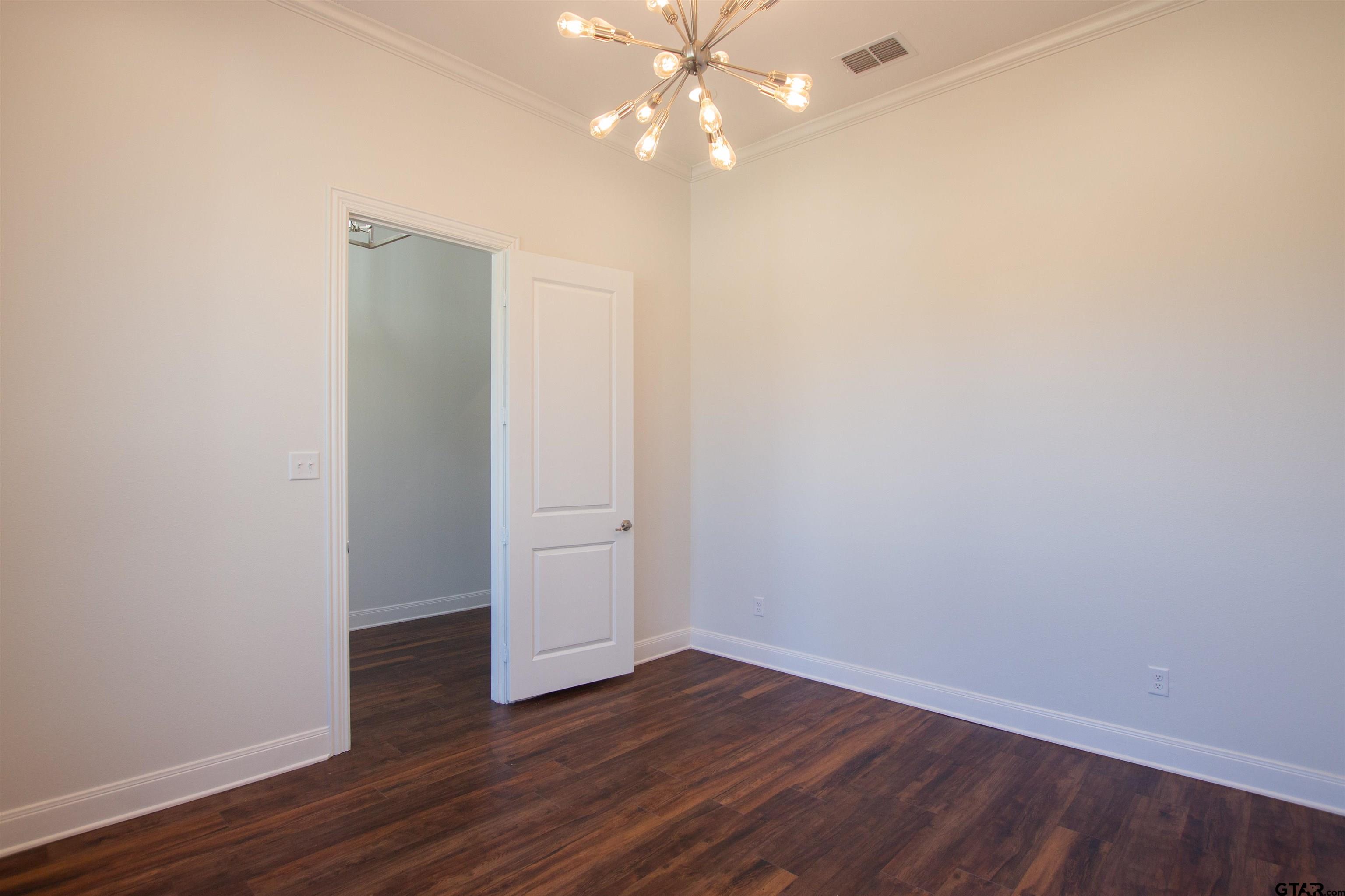 14716 Fallow Lane Tyler, TX 75706 - Photo 12 of 46 a view of an empty room with wooden floor