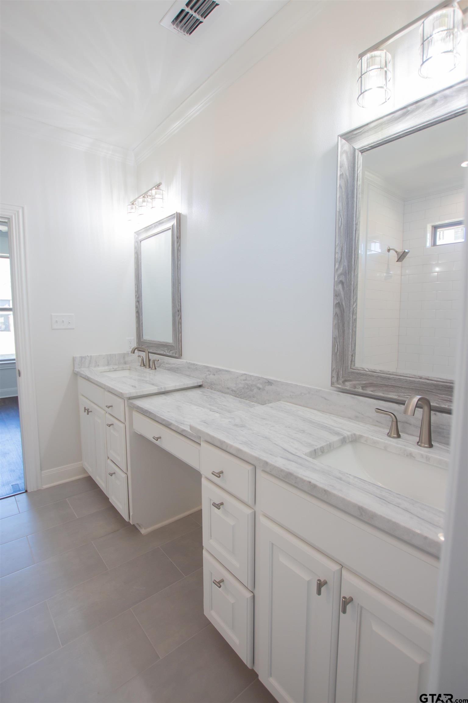 14716 Fallow Lane Tyler, TX 75706 - Photo 15 of 46 a bathroom with a granite countertop sink and white cabinets